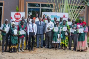 Charles Ichogor, Resident City Commissioner (Grey suit), Alele Rasmash, 3rd Back,(Grey suit) PostBank Arua Branch Manager, Kizito Enzama (3rd Left) a Personal Banker at PostBank Arua branch, together with representatives from the Federation of Small and Medium Sized Enterprises (FSME) and some of the cassava farmers at Edentz Hotel in Arua Town // POSTBANK PHOTO FILE