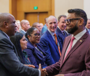 Prof. Benedict Oramah, President and Chairman of the Board of Directors of African Export-Import Bank (Afreximbank) exchanges pleasantries with H.E. Mohamed Irfaan Ali, President of Guyana (right) during the Guyana Energy Conference