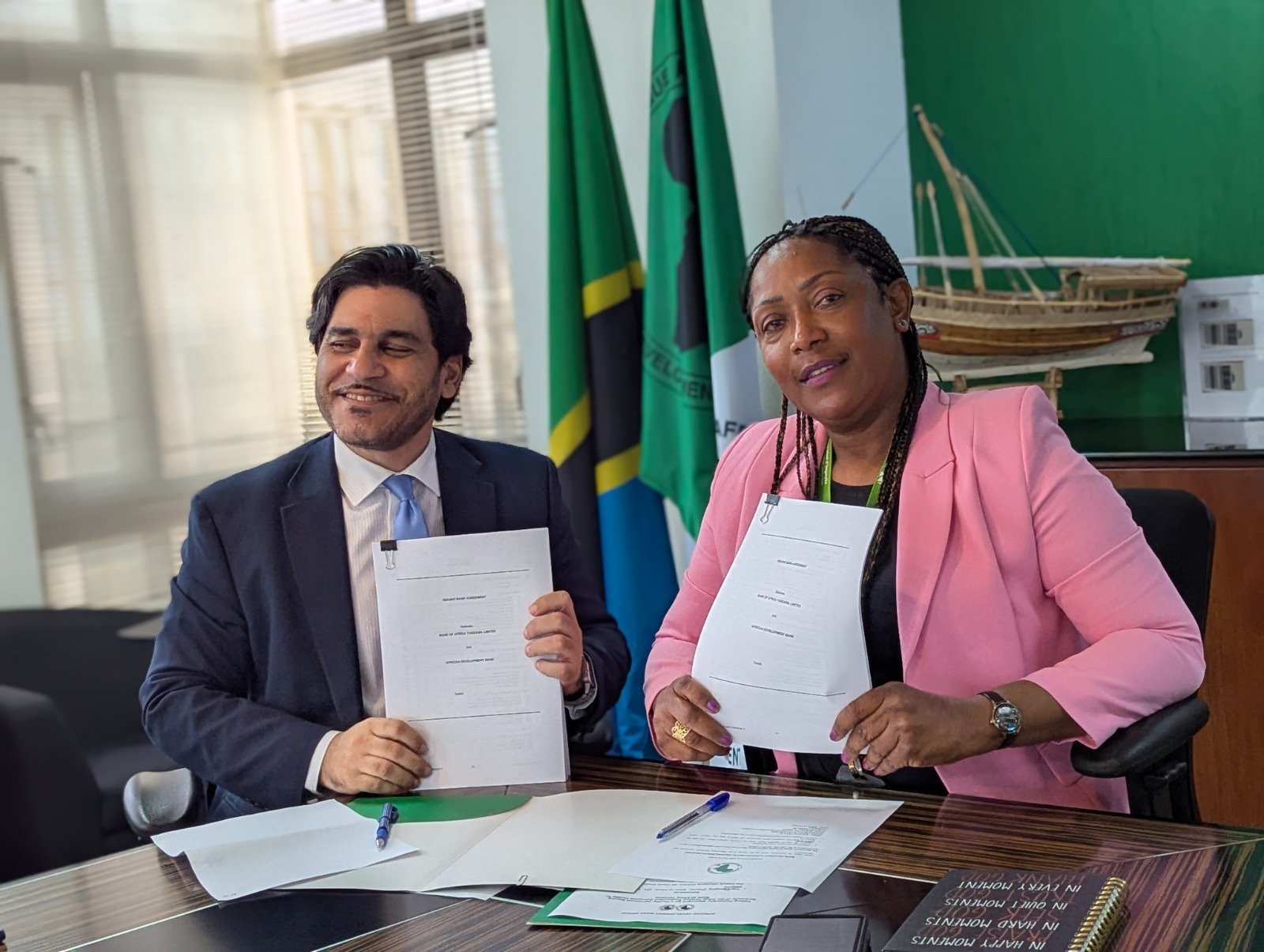 African Development Bank’s Tanzania Country Manager, Patricia Laverley (right), and BOAT’s Deputy Managing Director, Hamza Cherkaoui, display signed copies of the $7.5 million trade finance transaction guarantee agreement